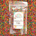 Packaged sensory bin filler with a label on a colorful background